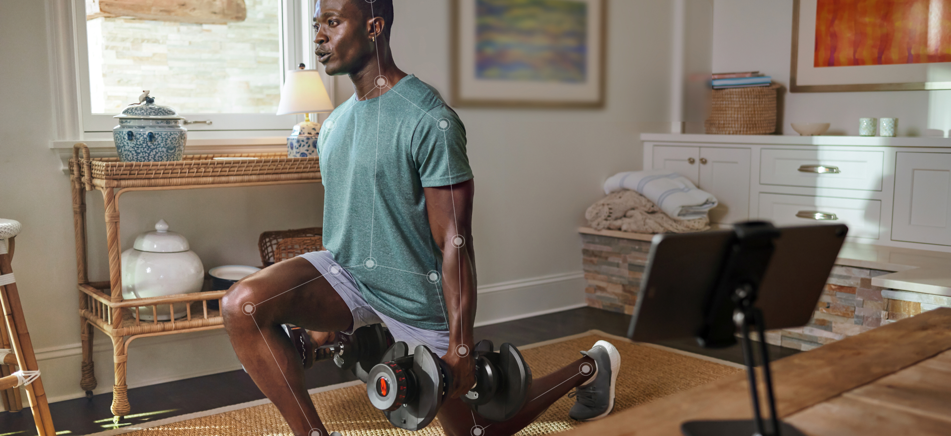 Man doing a lunge with dumbbell weights and using JRNY motion tracking