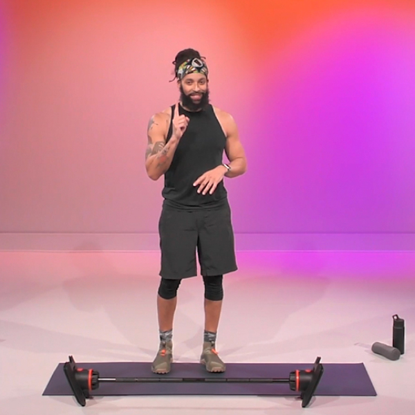 Male fitness trainer leads a barbell workout